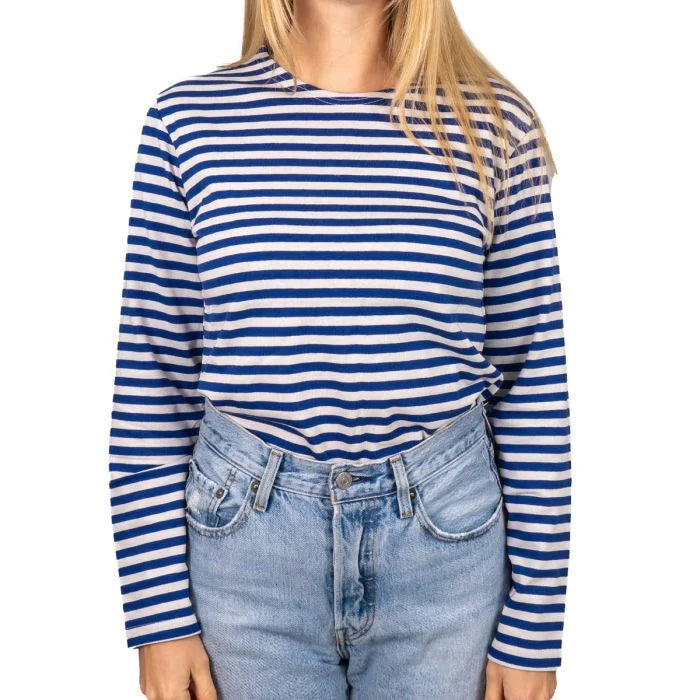 Female model wearing tucked-in long sleeve Russian Telnyashka striped shirt