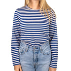 Female model wearing tucked-in long sleeve Russian Telnyashka striped shirt