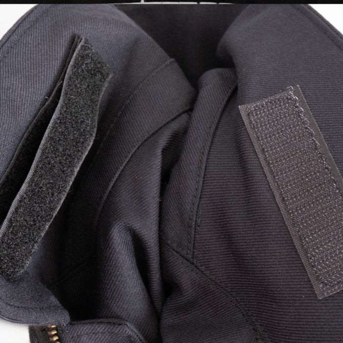 Close-up of hook-and-loop pocket closure and dark blue fabric texture on German fire service jacket