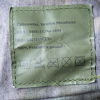 Close-up of military label on Dutch Army water bottle pouch with NSN 8465-17-114-3444 and care instructions