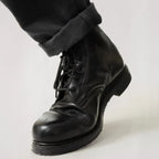 Close up view of eyelet lacing system and stitched toe cap on Austrian army boot