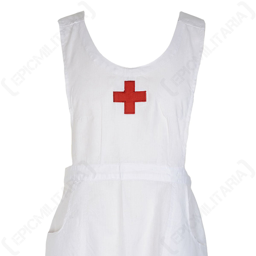 Close-up of the Red Cross nurse apron chest area, showing the textured cotton fabric and the iconic red cross emblem.