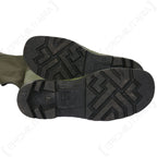 Bottom view of the rubber boot soles showing the deep tread pattern for traction on slippery surfaces.