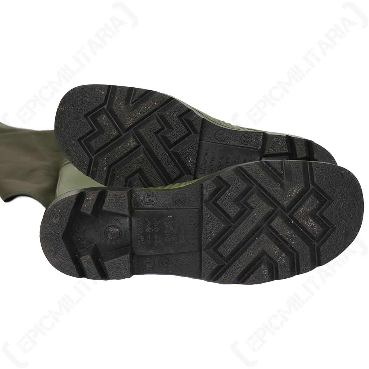 Bottom view of the rubber boot soles showing the deep tread pattern for traction on slippery surfaces.