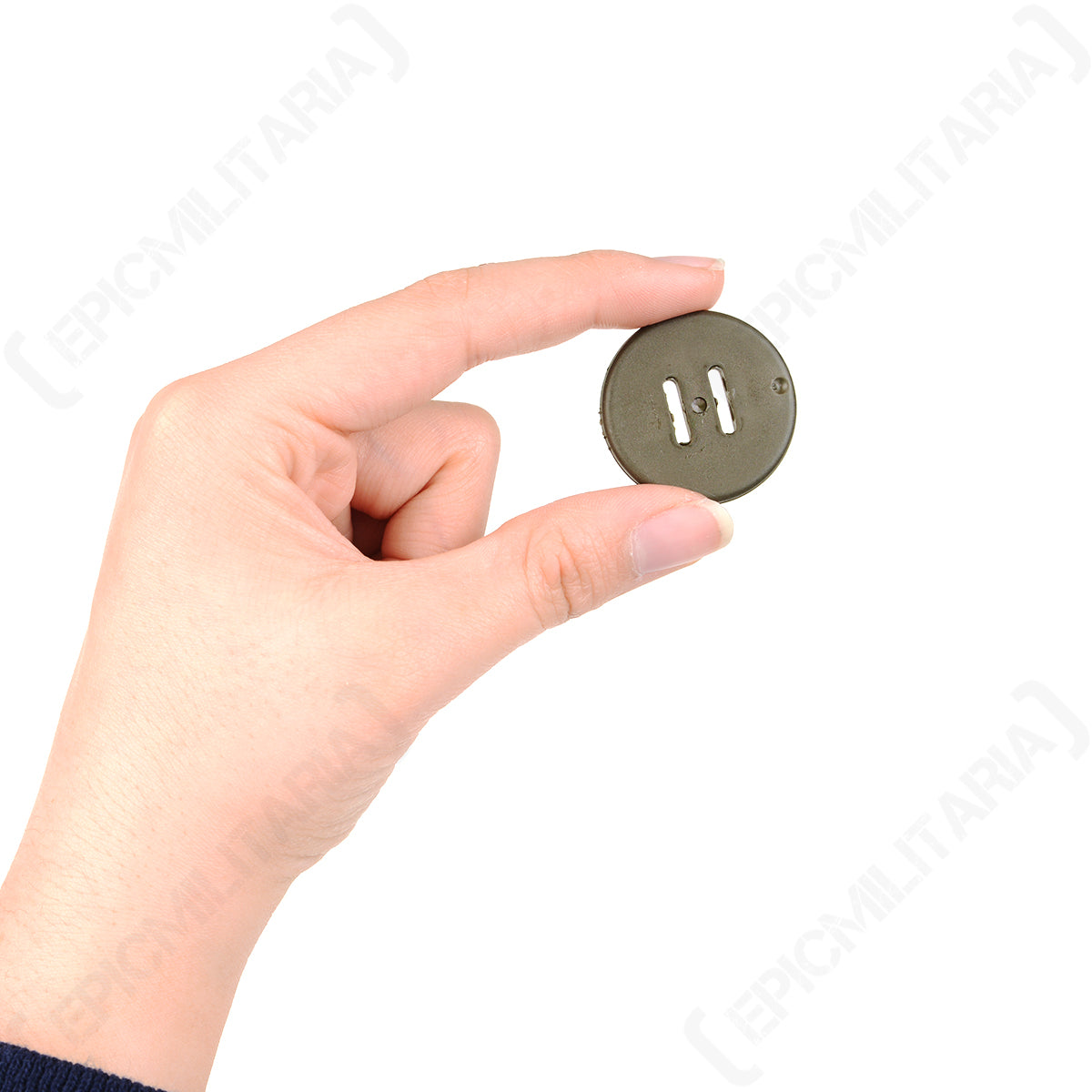 Close-up of a hand holding a single 31mm khaki military style button, highlighting the utilitarian two-slot design.