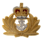 Front view of original British Royal Navy Officer metal cap badge featuring gold laurel wreath and silver fouled anchor