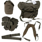 Overhead flat lay of the complete seven piece Greek Army M56 M1971 webbing set with belt, suspenders, pouches, canteen, and field pack
