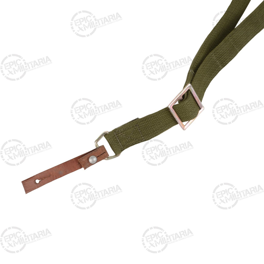 Detailed view of a Type 81 rifle sling showing the metal buckle adjustment mechanism, canvas webbing, and leather attachment hardware.