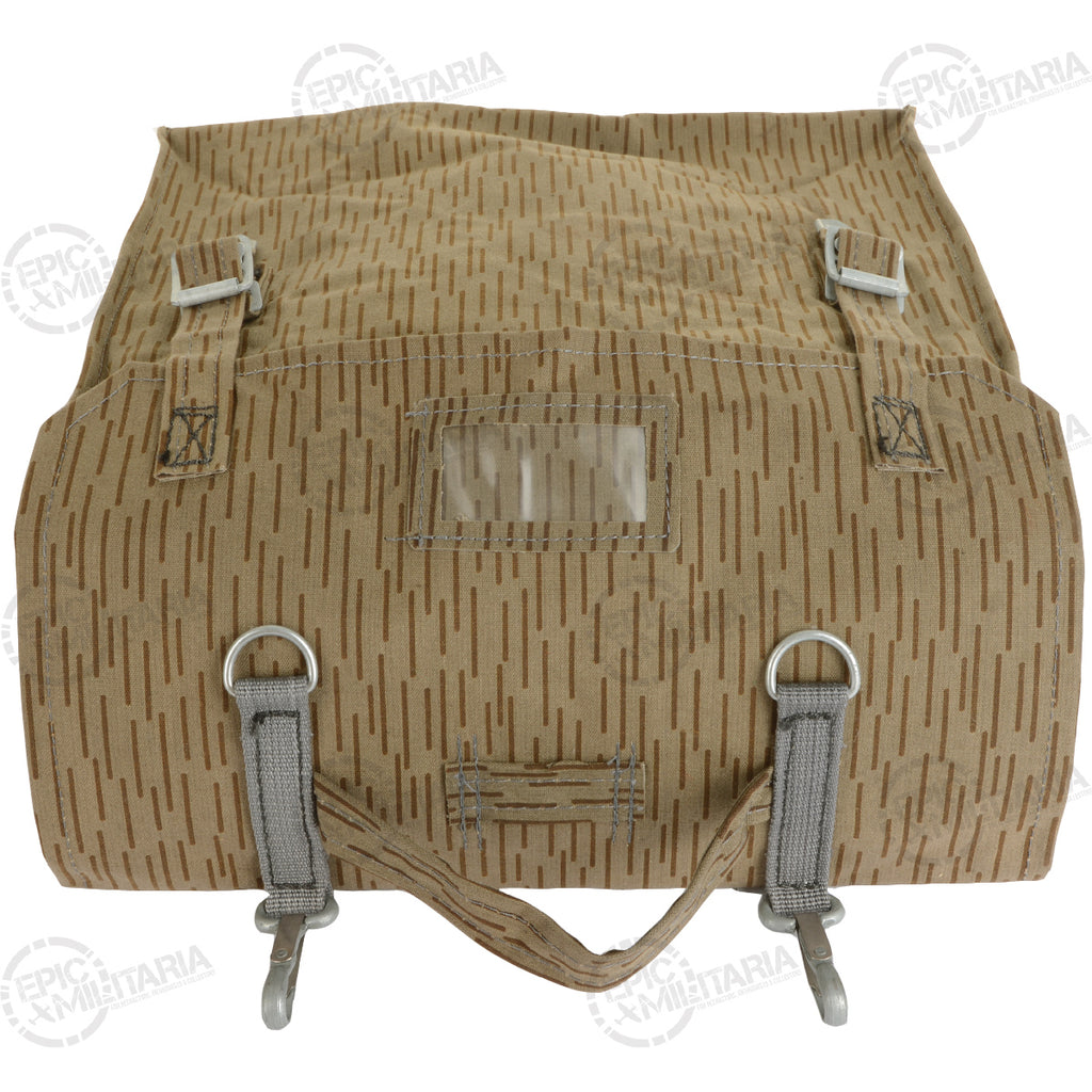 Top-down view of the NVA rucksack with the flap folded back to show the metal buckles and clear plastic identification sleeve.