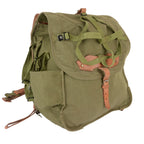 Side profile of an olive Romanian Army canvas rucksack with leather straps and helmet harness.