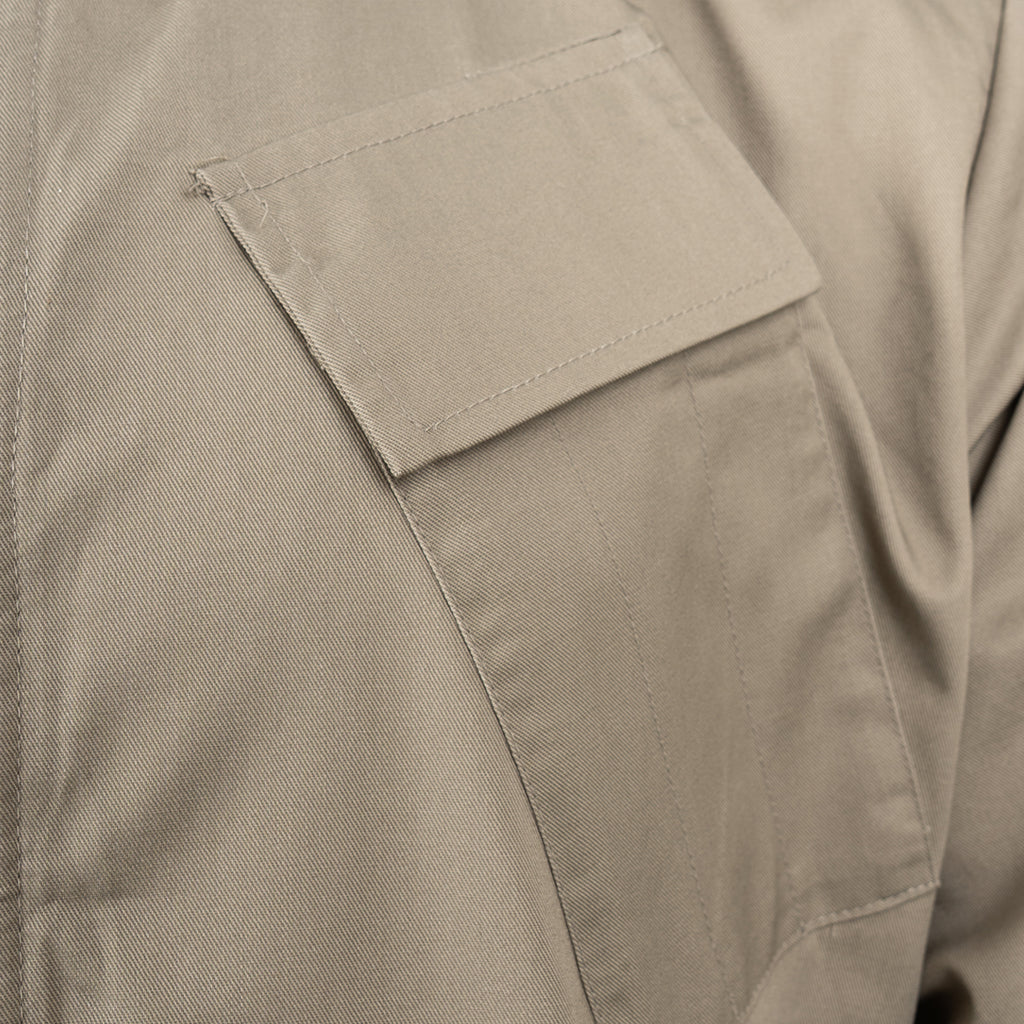 Close-up detail of the angled chest pen pocket on the RAF lightweight coveralls, showing precise stitching and fabric texture.
