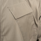 Close-up detail of the angled chest pen pocket on the RAF lightweight coveralls, showing precise stitching and fabric texture.