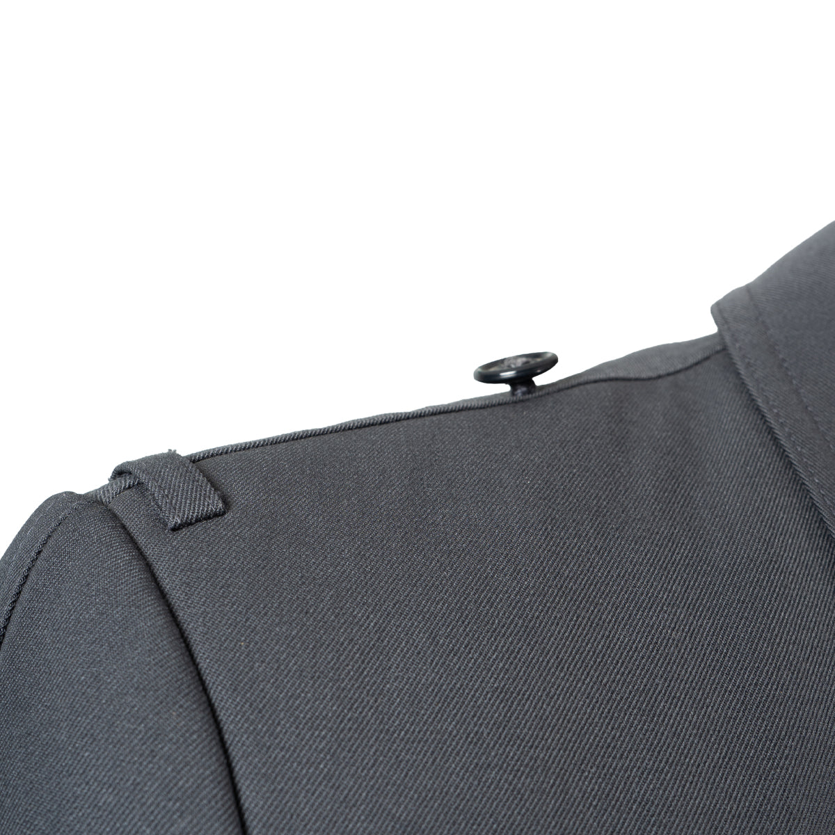 Close-up of the shoulder epaulet and button detail on the German Army surplus trench coat.