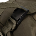 Close-up of a brown bag with a black buckle and strap.
