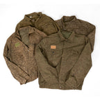 Collection of multiple used-like new Czech Army M92 field jackets showing variations in the vintage camouflage patterns.