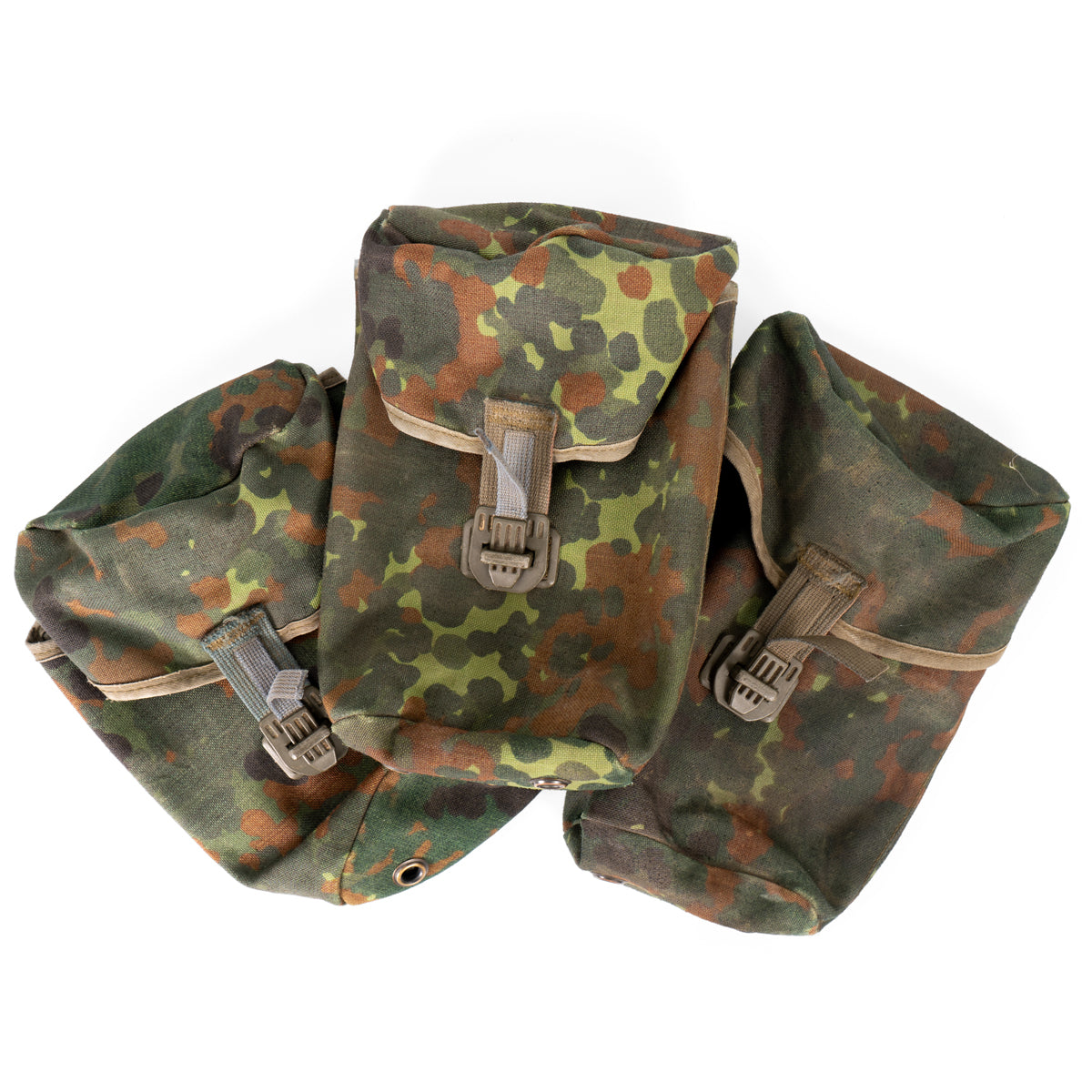 Three authentic German Army Flecktarn canteen pouches arranged together, showcasing the classic camouflage pattern and variations in surplus condition.