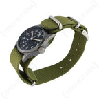 High angle view of the US Vietnam War service watch on olive green woven wristband
