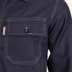 Close-up of chest pocket and red Sicur System tag on navy Italian work jacket