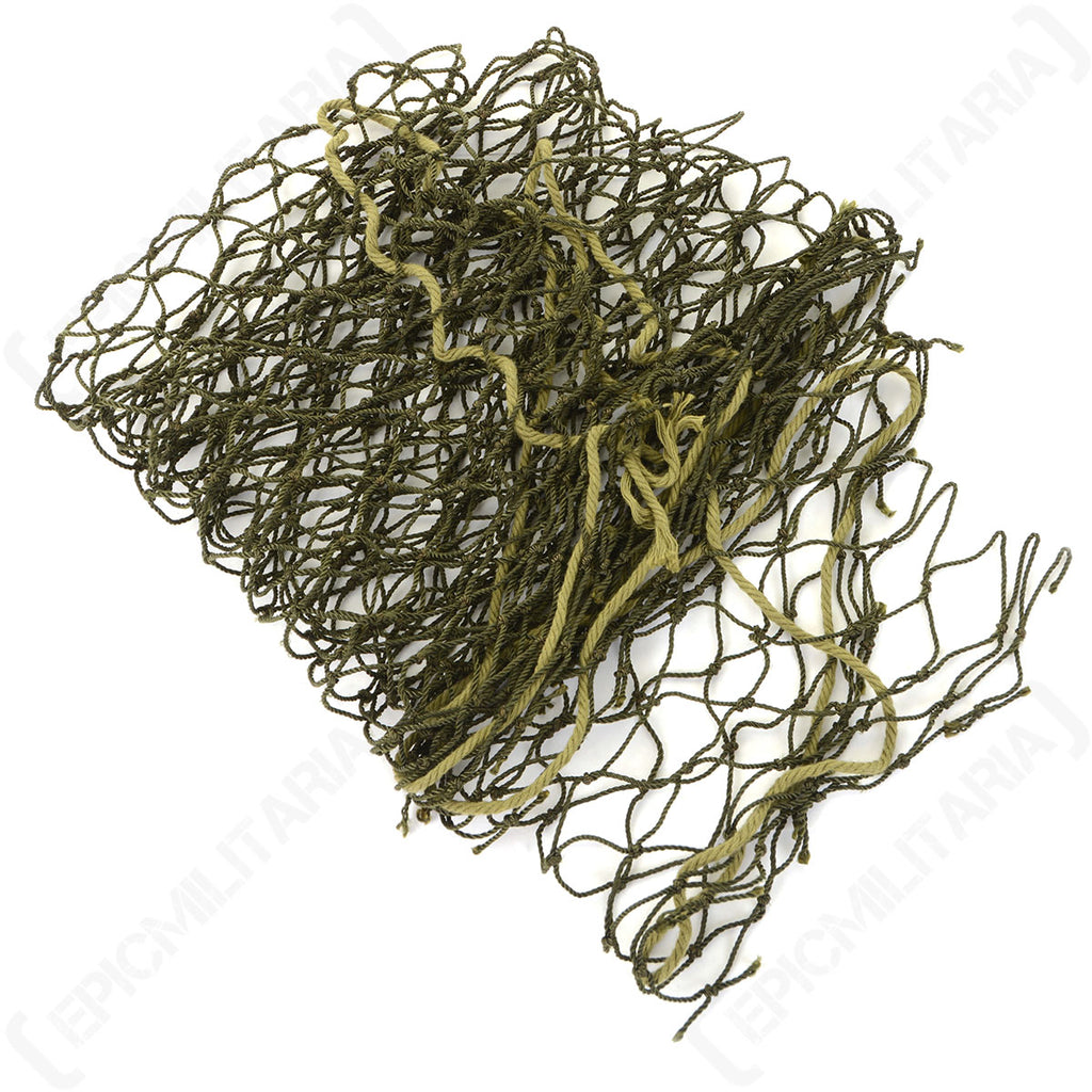 A folded stack of the olive drab helmet net cover, showcasing the layered texture and versatile attachment cords used for military camouflage gear.