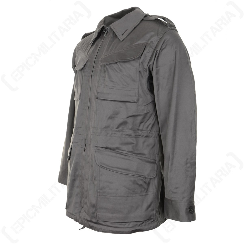 Angled view of the grey-green Danish M71 Civil Defence Parka showing side profile, sleeve detailing, and adjustable button cuffs.