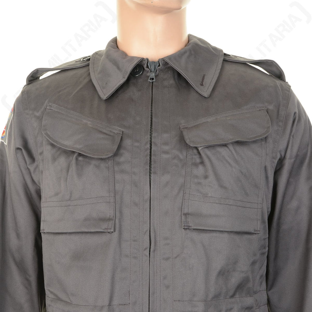 Close-up of the Danish M71 Civil Defence Parka chest area, displaying the zip collar, shoulder epaulets, and twin chest cargo pockets.