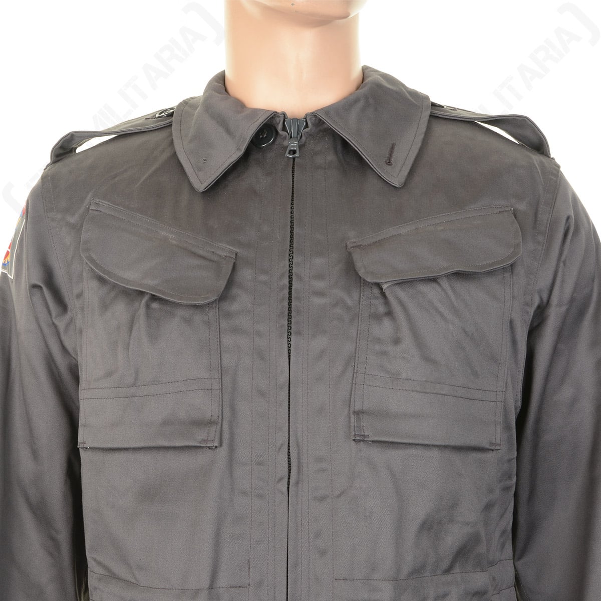 Close-up of the Danish M71 Civil Defence Parka chest area, displaying the zip collar, shoulder epaulets, and twin chest cargo pockets.