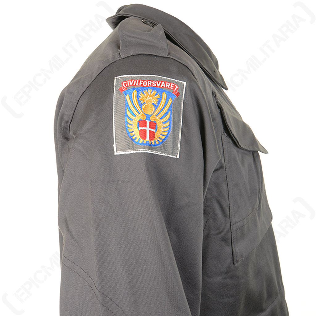 Detailed shot of the official Civil Defence Force insignia patch on the shoulder of the authentic Danish M71 military parka.