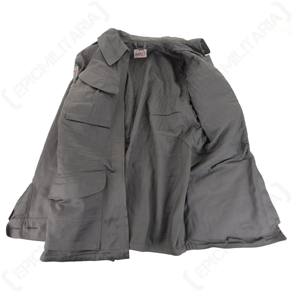 Interior view of the Danish M71 Civil Defence Parka showing the internal drawstring waist adjustment and original identification tag.