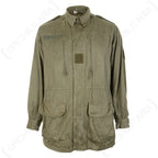 Original French M64 field jacket in olive drab with four front pockets, drawstring waist, and hook and loop patches for customisation.