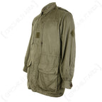 Side profile view of the French M64 military field jacket showing durable olive cotton construction and adjustable button cuffs.
