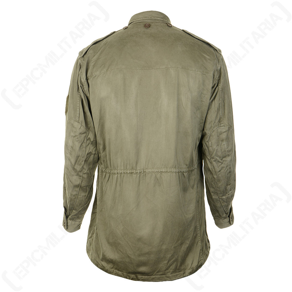 Rear view of the vintage French M64 field jacket, highlighting the classic utility cut, waist adjustment, and durable military design.