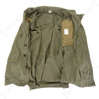 Interior view of the French army M64 field jacket, showing the breathable lining, button closure system, and genuine surplus manufacturer label.