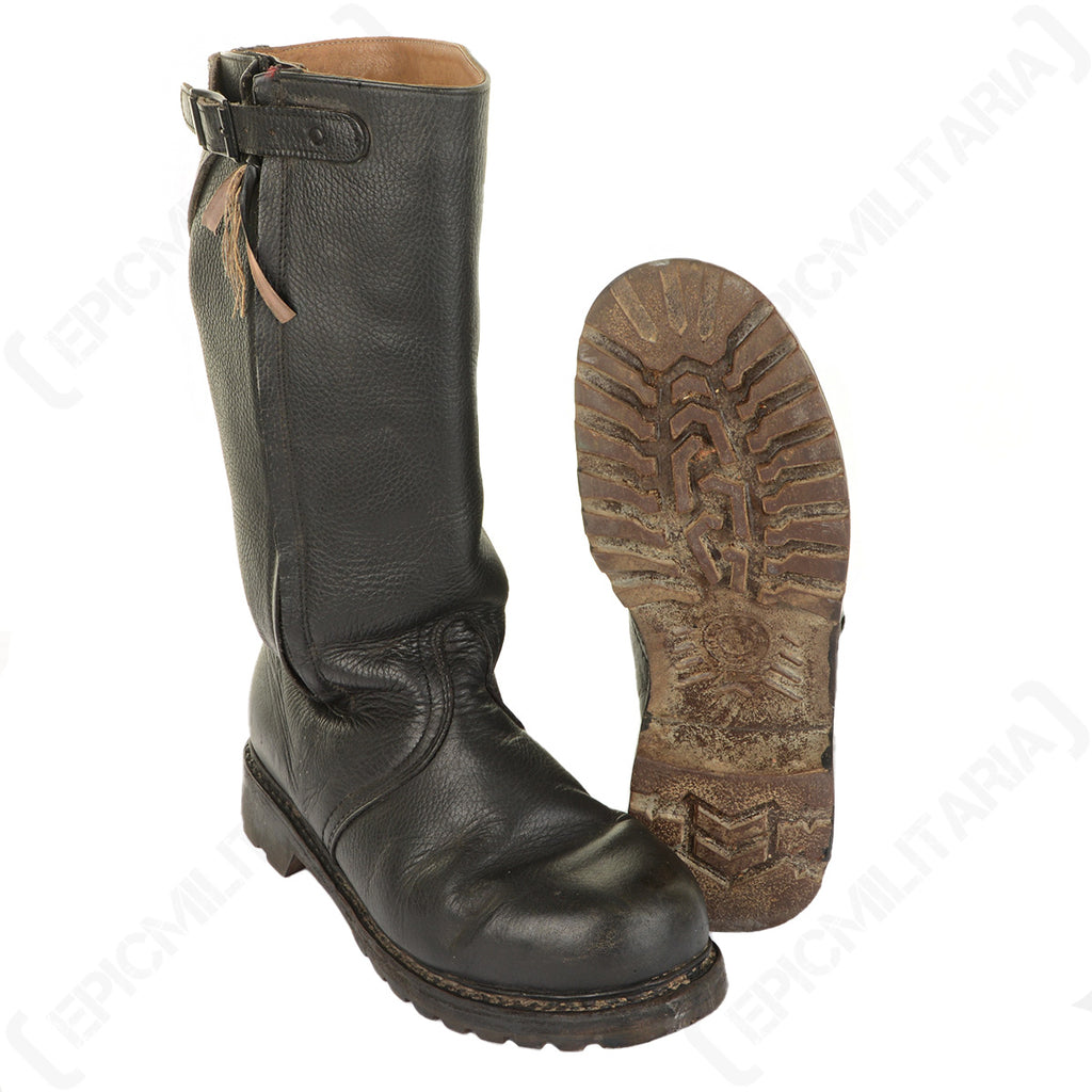 Original Bundesmarine leather jackboot upright next to a view of its textured rubber tread sole.