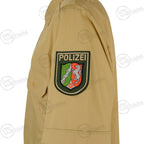 Close-up detail of the sleeve on the German police tan shirt featuring the embroidered Polizei patch with traditional German crest.