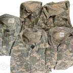 Group shot of multiple US Army ACU field jackets, showing varied sizing labels inside the collars.