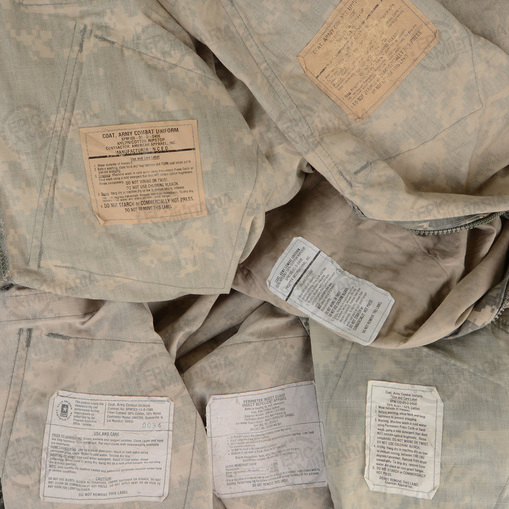 Detailed view of various internal care and manufacturing labels found inside authentic US Army combat uniform jackets.