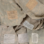 Detailed view of various internal care and manufacturing labels found inside authentic US Army combat uniform jackets.