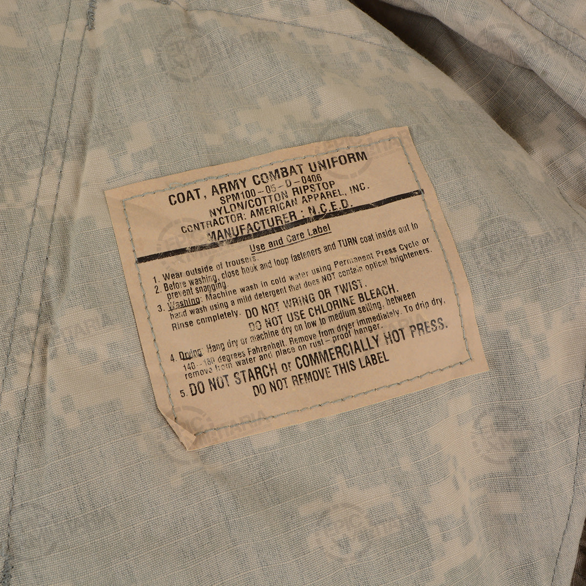 Close-up of a specific Army Combat Uniform care label detailing washing and maintenance instructions for nylon cotton ripstop.