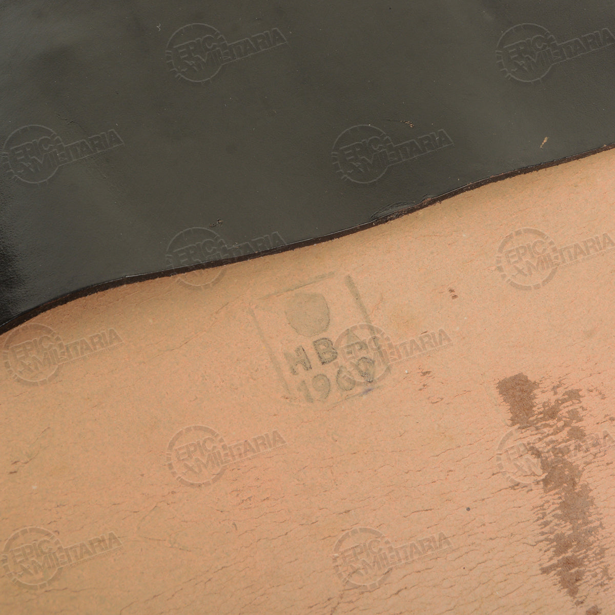 Close-up detail of internal markings stamped HB 1960 on the light-colored lining of a vintage black leather map case.