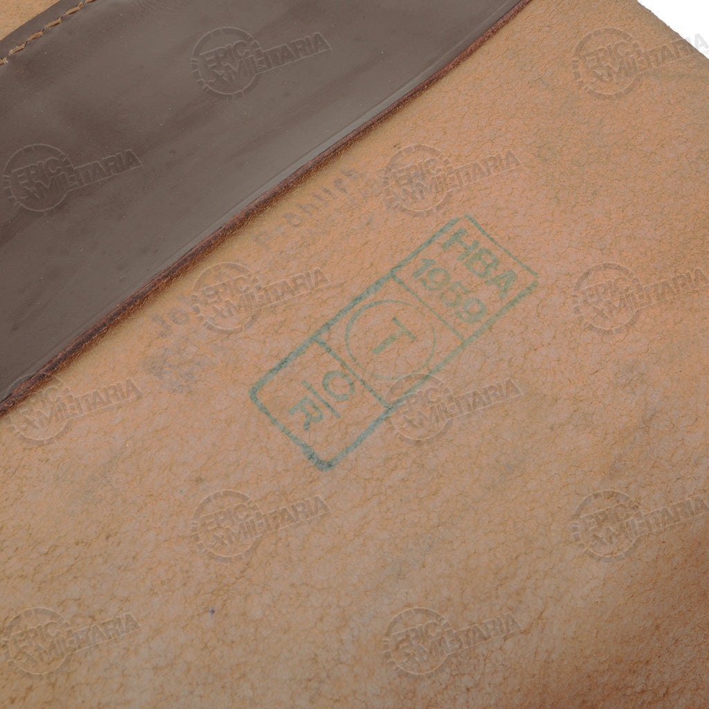 Macro detail of a green ink stamp marking showing HB 1960 on the interior light-colored leather of a map case.