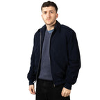 Male model wearing the blue British RAF General Purpose Jacket over a grey sweater, zipped up.