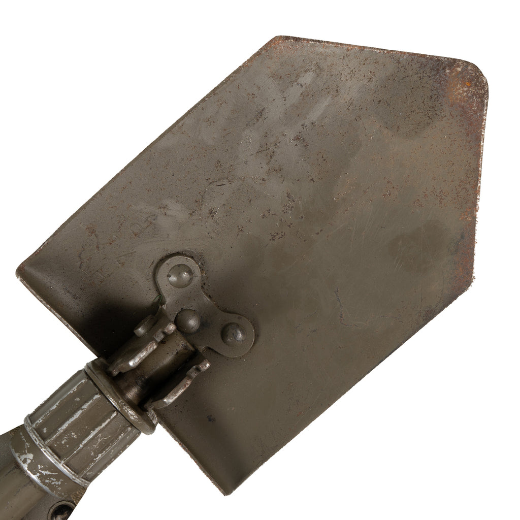 Close-up of the Austrian Bundesheer military shovel blade showing the rugged steel construction and hinged folding mechanism.