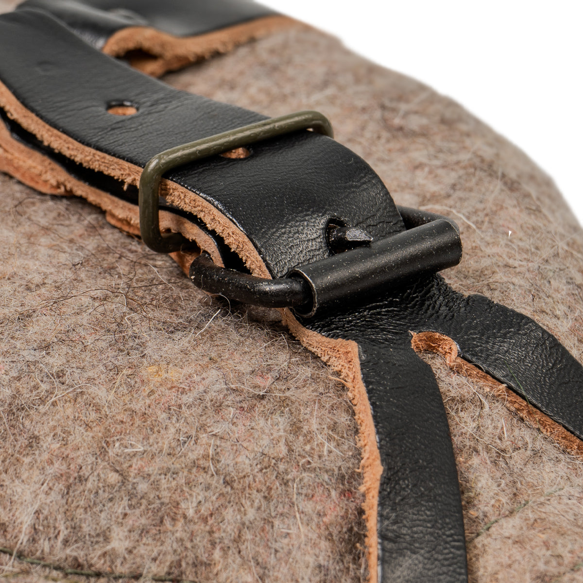 Close-up detail of the metal buckle and rivet hardware on the black leather strap securing the Czech M60 canteen cover.
