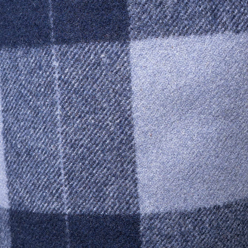 Detailed texture shot of the interior blue and grey plaid wool lining of the German Army trench coat.
