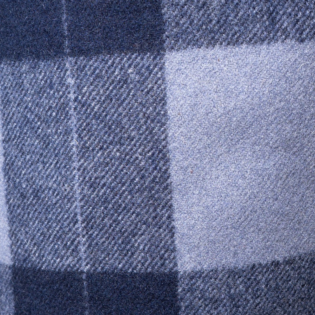 Detailed texture shot of the interior blue and grey plaid wool lining of the German Army trench coat.