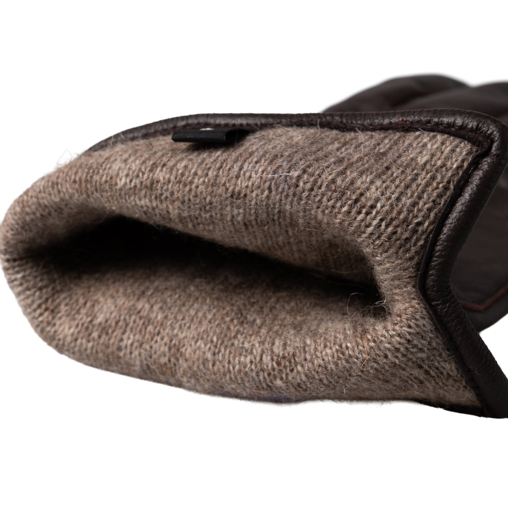 Close-up view of the interior of a Dutch Army leather glove, revealing the insulating wool lining for warmth.