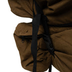 Close-up of the heavy-duty side storage compartment and rugged nylon webbing on an authentic SADF Pattern 83 military surplus rucksack.