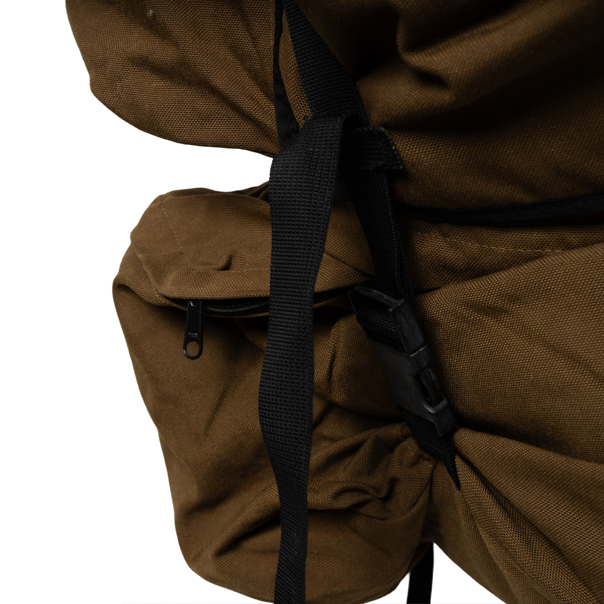 Close-up of the heavy-duty side storage compartment and rugged nylon webbing on an authentic SADF Pattern 83 military surplus rucksack.