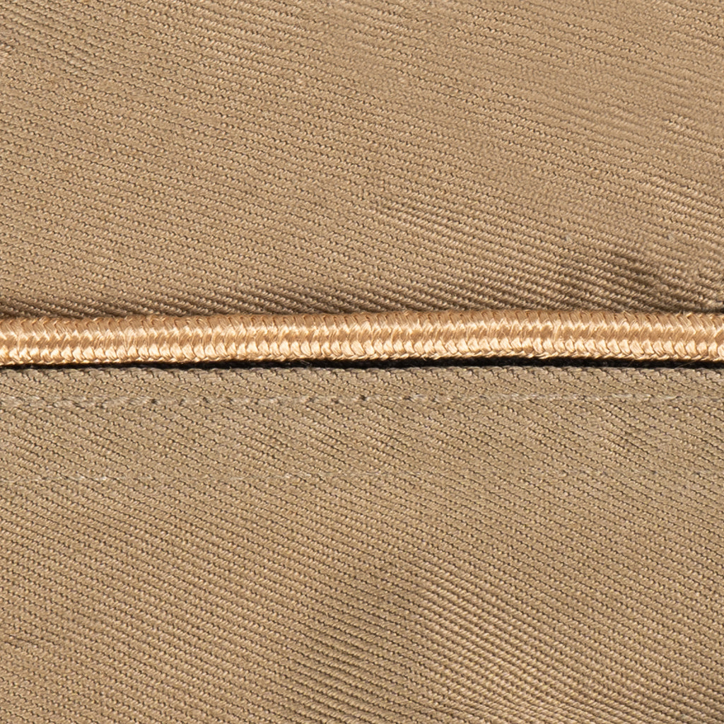 Close-up of tan piping detail on an authentic WW2 era US Army Garrison Cap, highlighting the durable cotton weave.