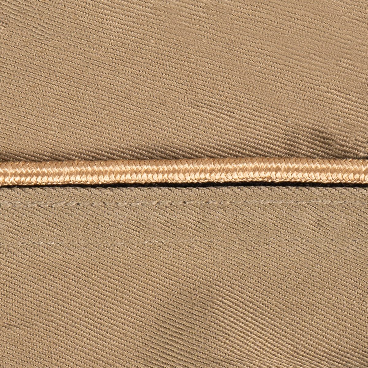 Close-up of tan piping detail on an authentic WW2 era US Army Garrison Cap, highlighting the durable cotton weave.